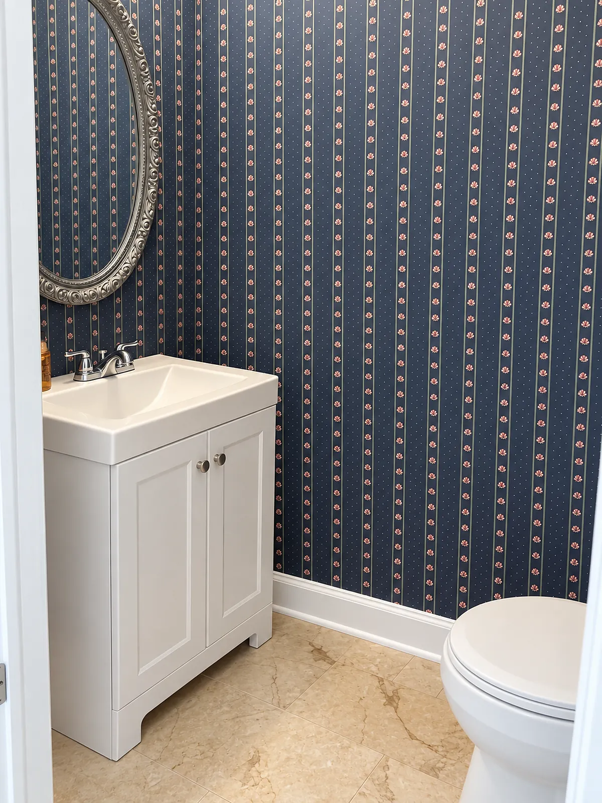 Half bathroom with a sink vanity and wallpapered walls