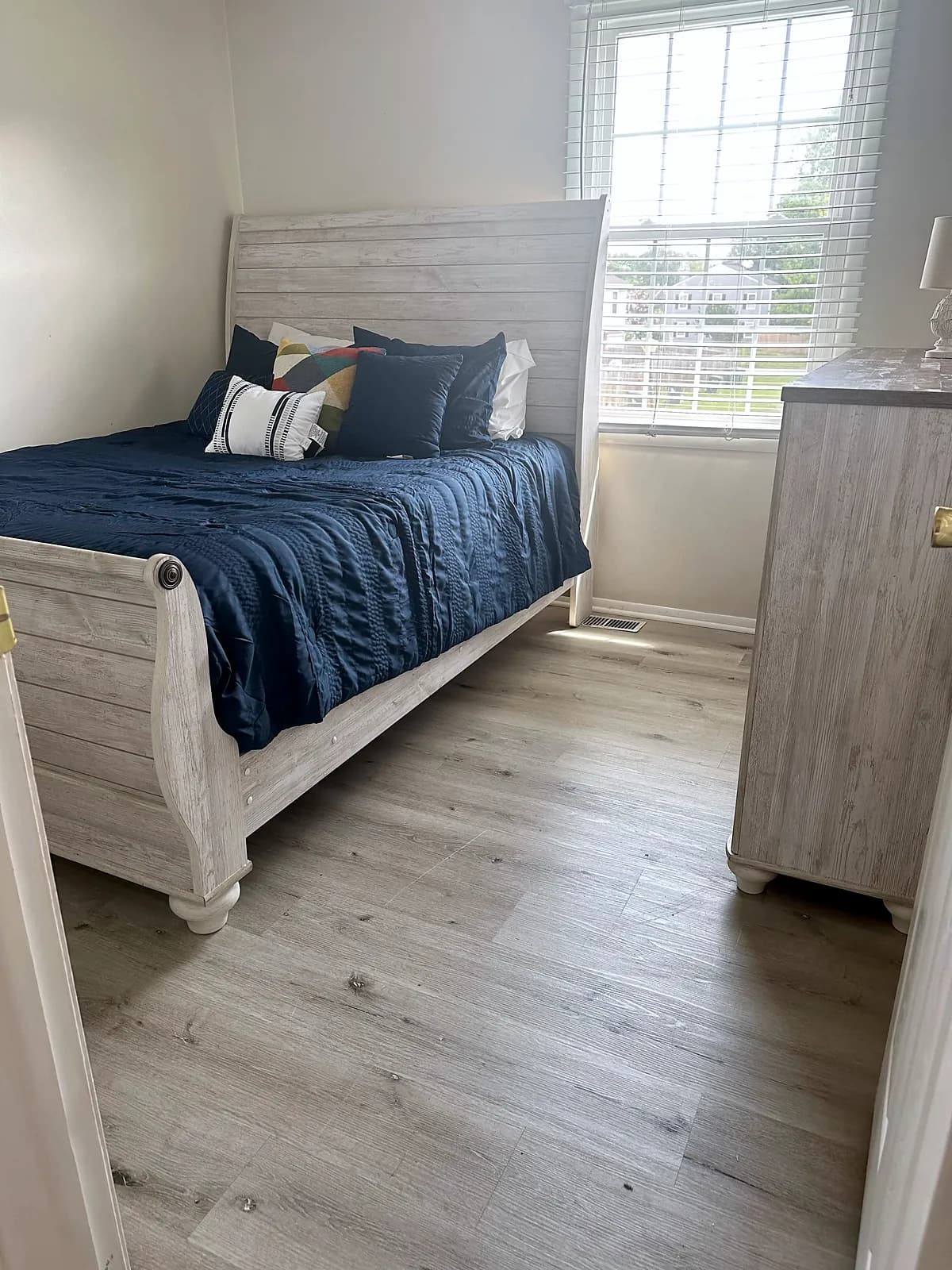 Bedroom with a white sleigh bed and a matching dresser